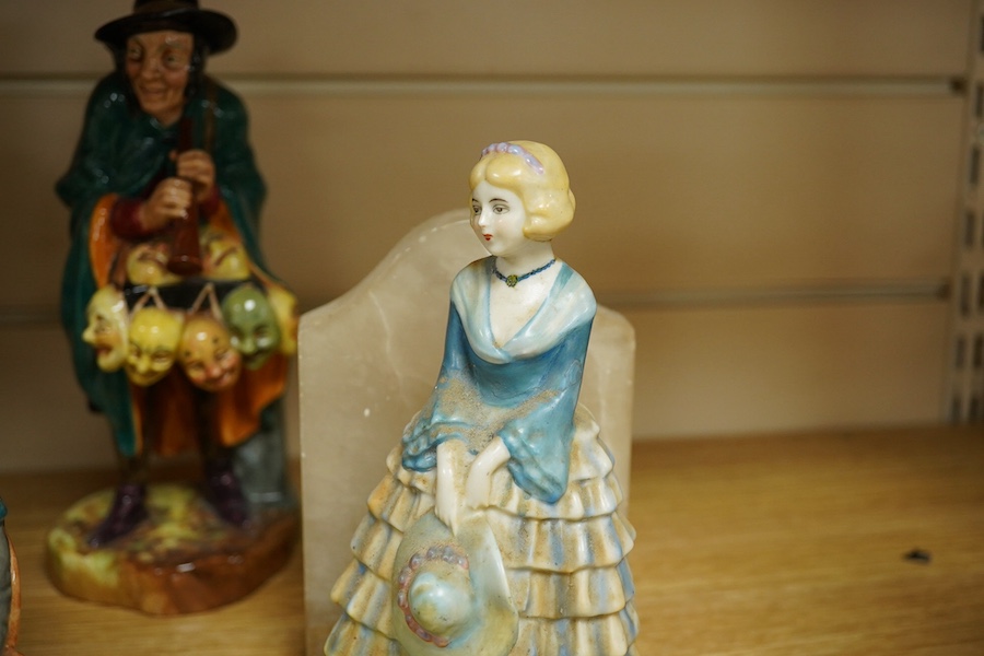 Two Royal Doulton figures comprising; The Mask Seller and Pied Piper together with three other figures and a pair of alabaster bookends, largest 24cm high. Condition - mostly fair/good